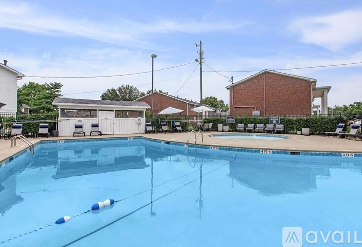 A large swimming pool with a blue and white striped buoy floating in the middle.