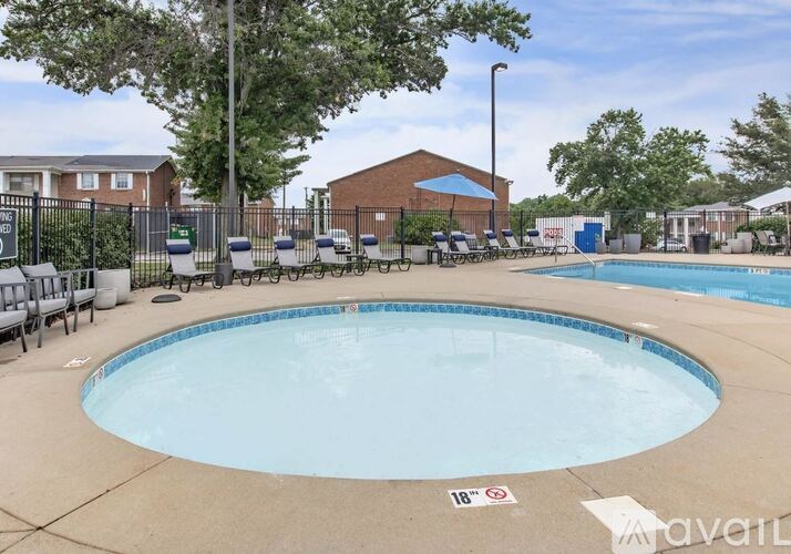 A round above ground pool with a fence around it.