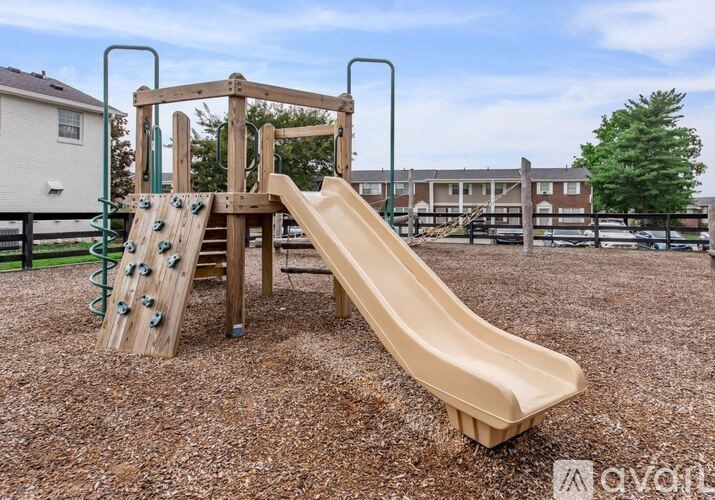 A playground with a slide and a climbing structure.