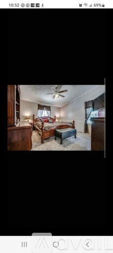 A room with a bed and a ceiling fan.