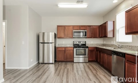 A kitchen with wooden cabinets and stainless steel appliances.