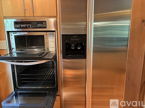 A modern kitchen with a stainless steel oven and microwave.