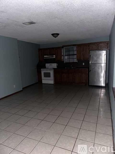 A kitchen with a white fridge, white oven, and white microwave.