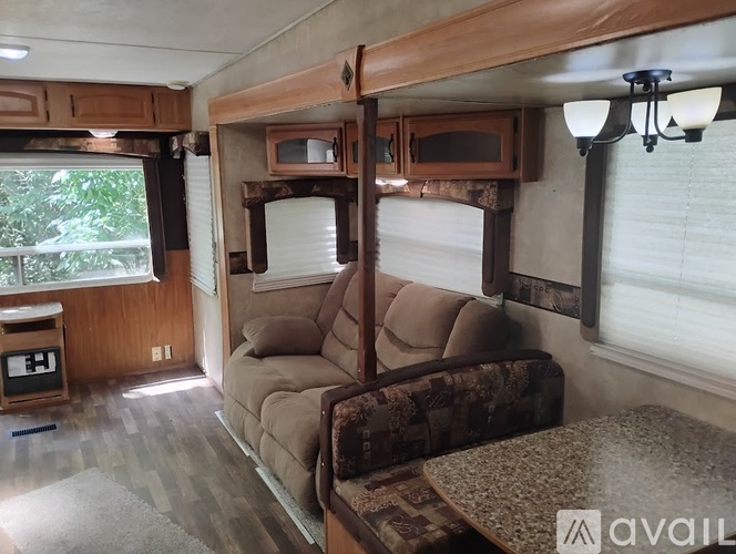 A living room with a couch and a table in a camper.