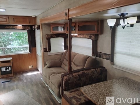 A living room with a couch and a table in a camper.