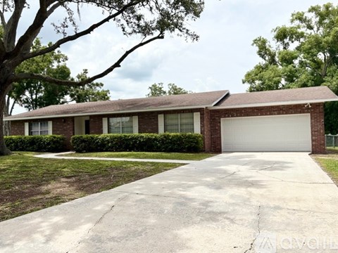 A house with a white garage door and a driveway in front.