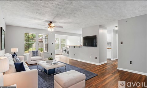 A living room with a white couch and a coffee table.