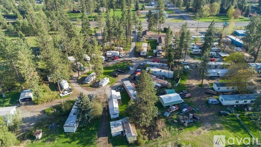 A bird's eye view of a campground with numerous RVs and trailers.