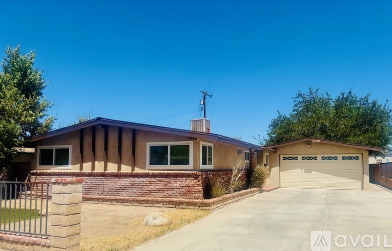 A house with a garage and a driveway is available for sale.