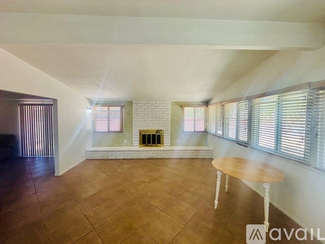 A room with a fireplace and a table in it.