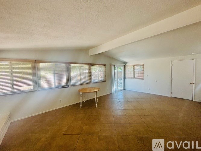 A room with a table and chairs in it.