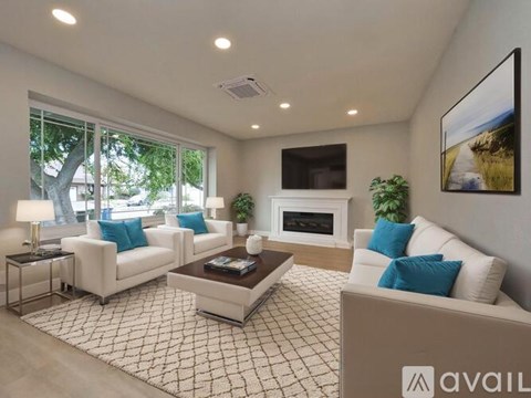 A living room with a fireplace and a painting on the wall.