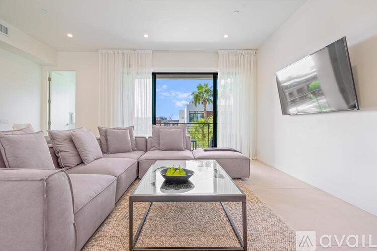 A modern living room with a large window overlooking a cityscape.