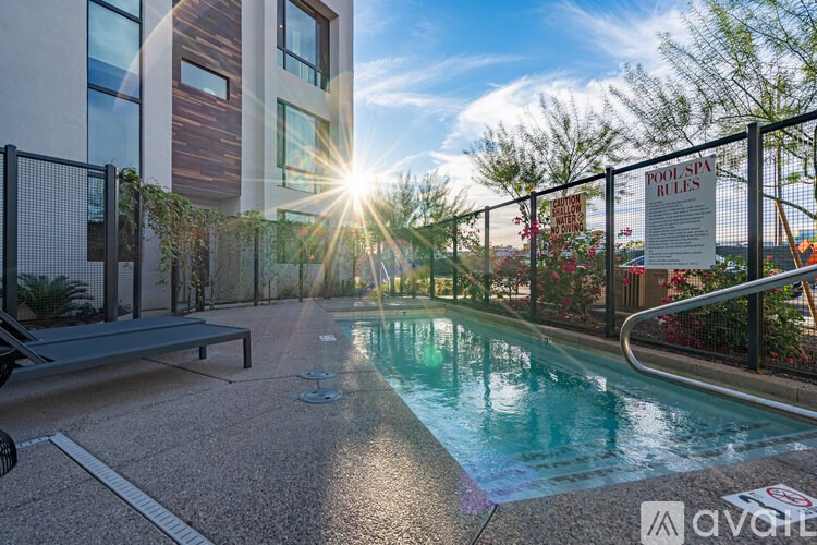 A pool with a sign that says "POOL RULES" in the background.