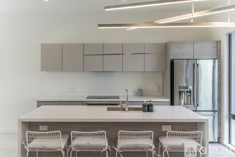 A modern kitchen with a white table and chairs.