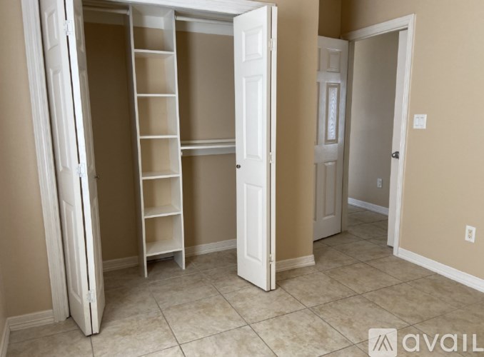A room with a white closet and a ladder.