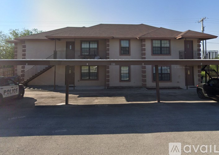 A house with a police car parked in front.