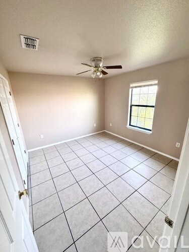 A room with a ceiling fan and a window.