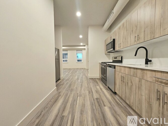 A kitchen with wooden cabinets and a modern design.