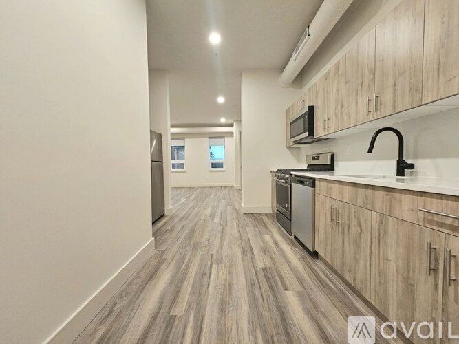A kitchen with wooden cabinets and a modern design.
