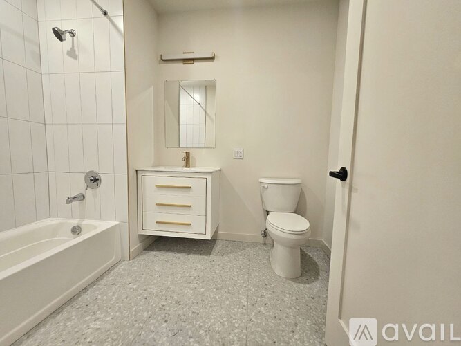 A white bathroom with a toilet, sink, and bathtub.