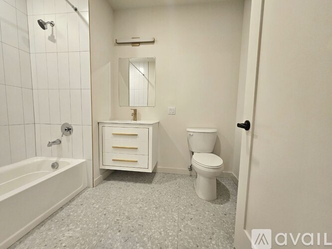 A white bathroom with a toilet, sink, and bathtub.