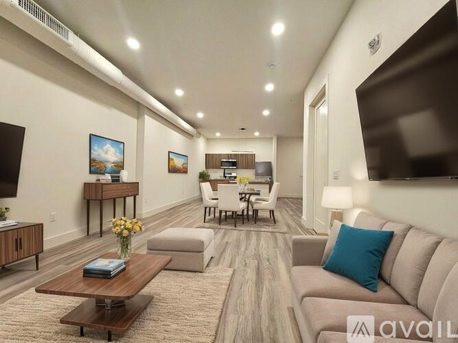 A living room with a couch, coffee table, and television.