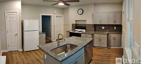A kitchen with a white refrigerator and a sink.