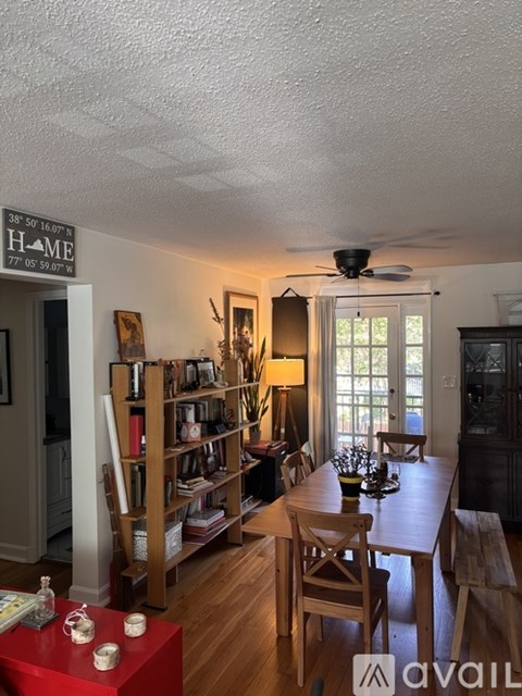 A living room with a dining table and chairs.
