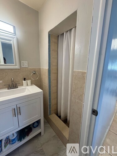 A bathroom with a white sink and a white cabinet.