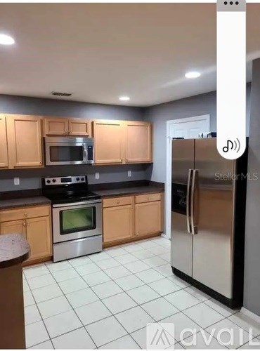 A kitchen with a stove, oven, and refrigerator.