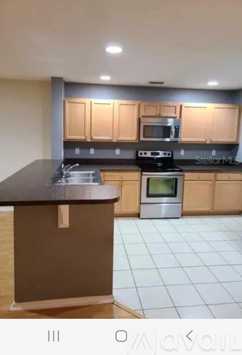 A kitchen with a stove top oven and microwave.