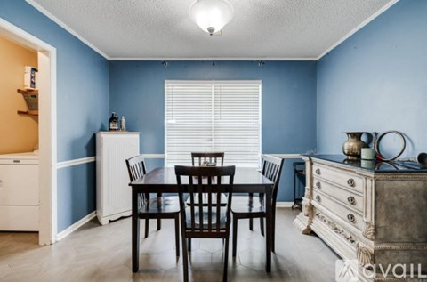 A dining room with a table set for two.