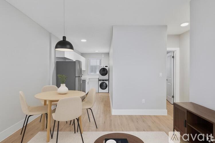A modern dining room with a round table and chairs.