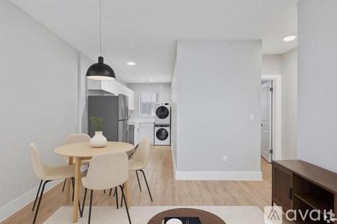 A modern dining room with a round table and chairs.