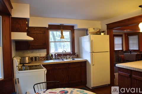 A kitchen with wooden cabinets and a white refrigerator.