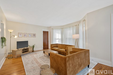 A living room with a brown couch and a television.