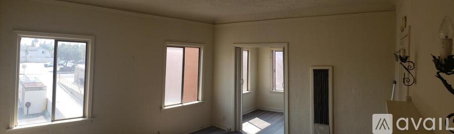 A room with a window and a door.