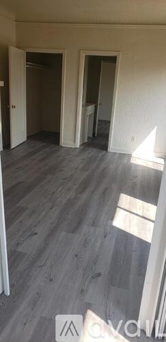 A room with grey flooring and white walls.