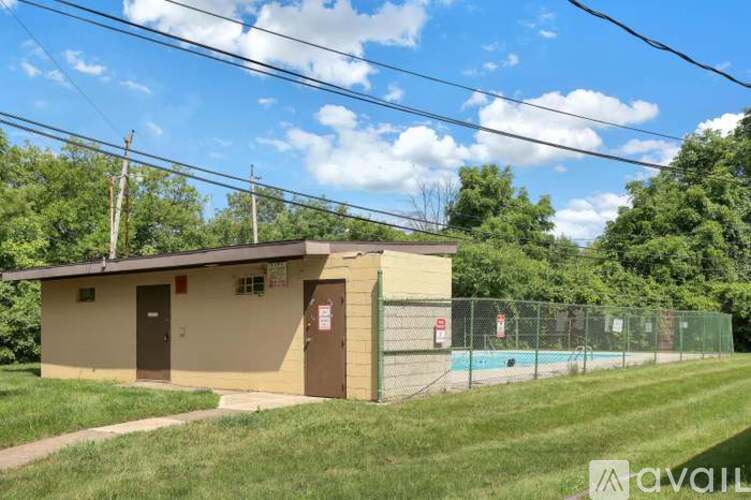 A small building with a pool in the backyard.