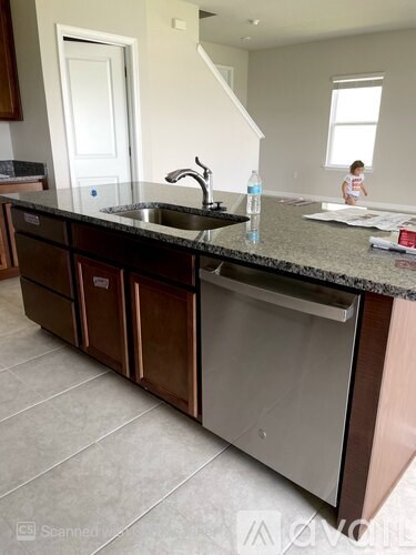 A kitchen with a granite counter top and a sink.