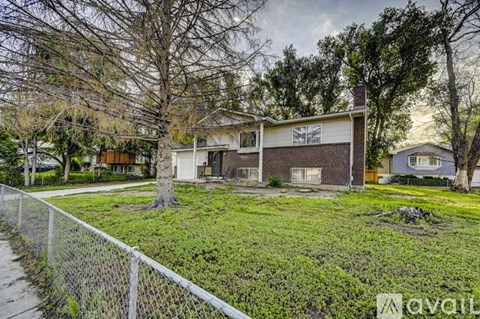 A house with a white fence in front of it.