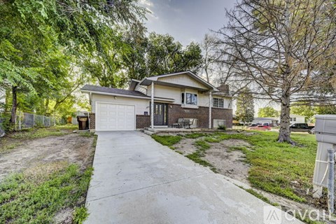 A house with a driveway in front of it.