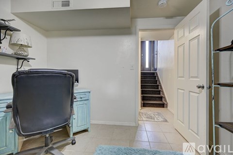 A room with a chair and a cabinet.