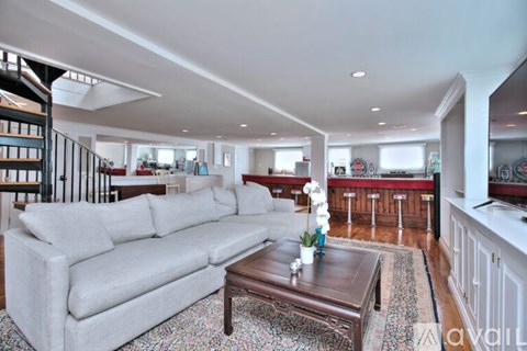 A living room with a grey couch and a coffee table.