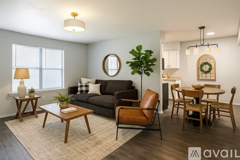 A room with wooden flooring and a window with blinds.
