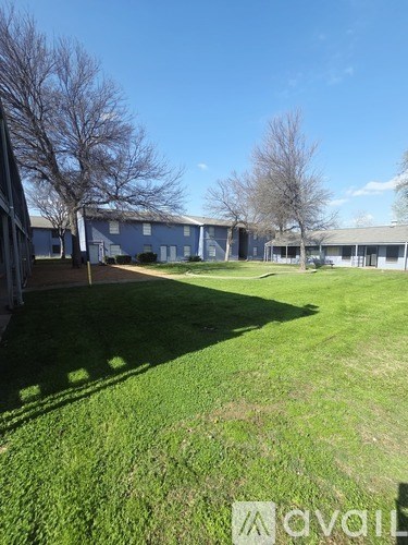 A grassy field with a building in the background.