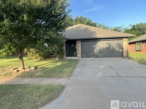 A house with a garage and a driveway is for sale.