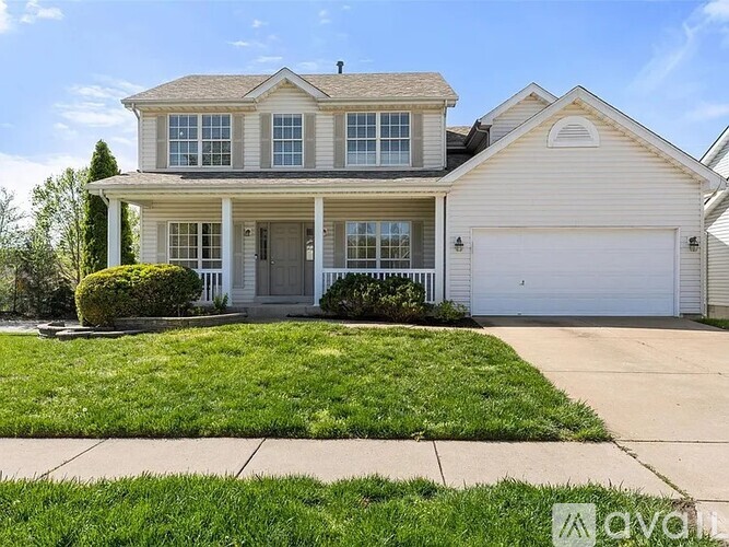 A two-story house with a white garage door and a grey roof.