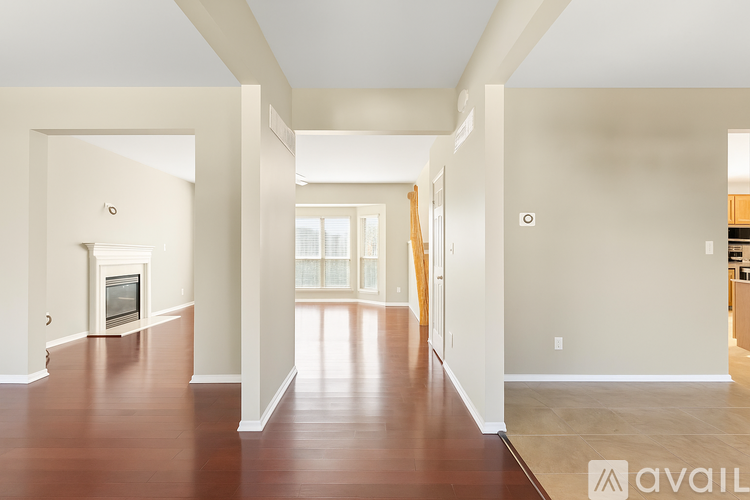 A spacious living room with a fireplace and hardwood floors.